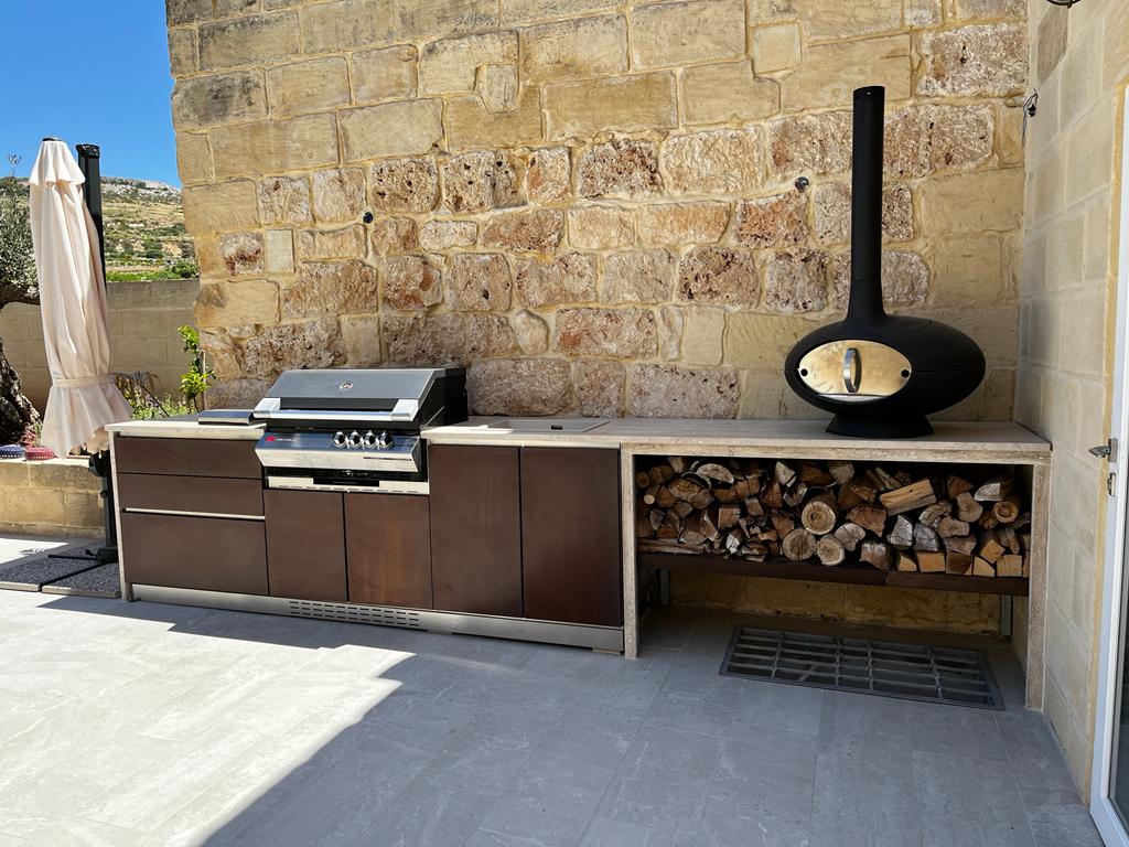 Designer outdoor kitchen with gas barbeque and pizza oven